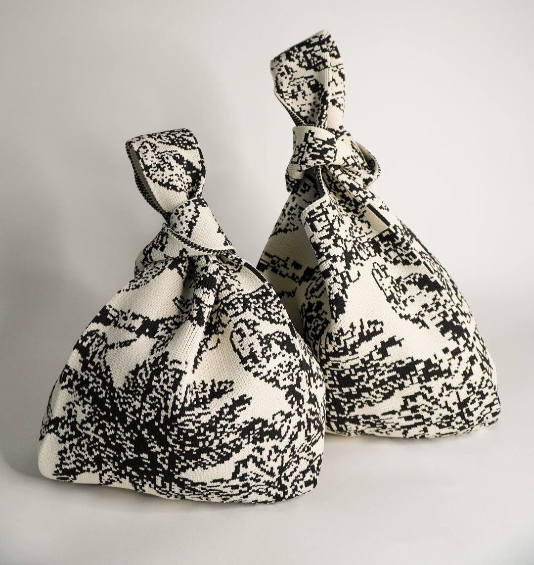Pair of Palm Beach black handbags with knotted handles, black/white woven fabric