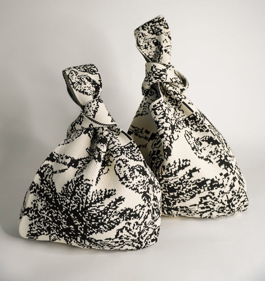 Pair of Palm Beach black handbags with knotted handles, black/white woven fabric