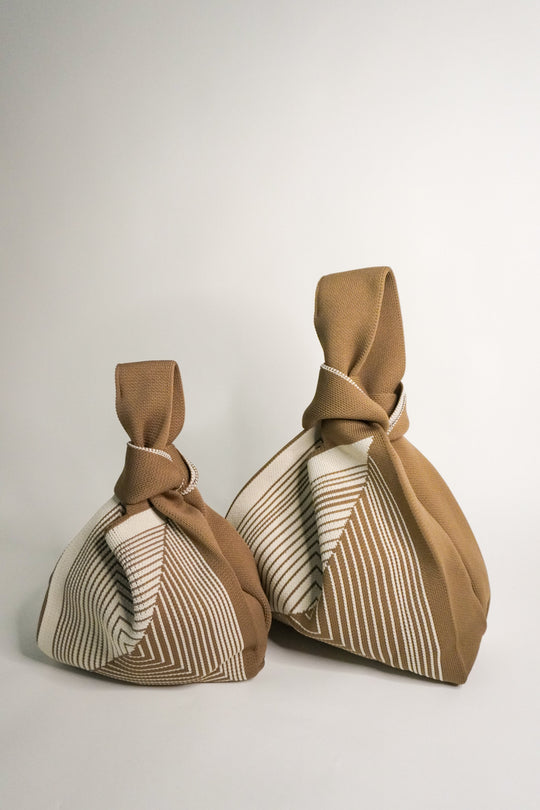 Small and large beige labyrinth handbags with knotted handles