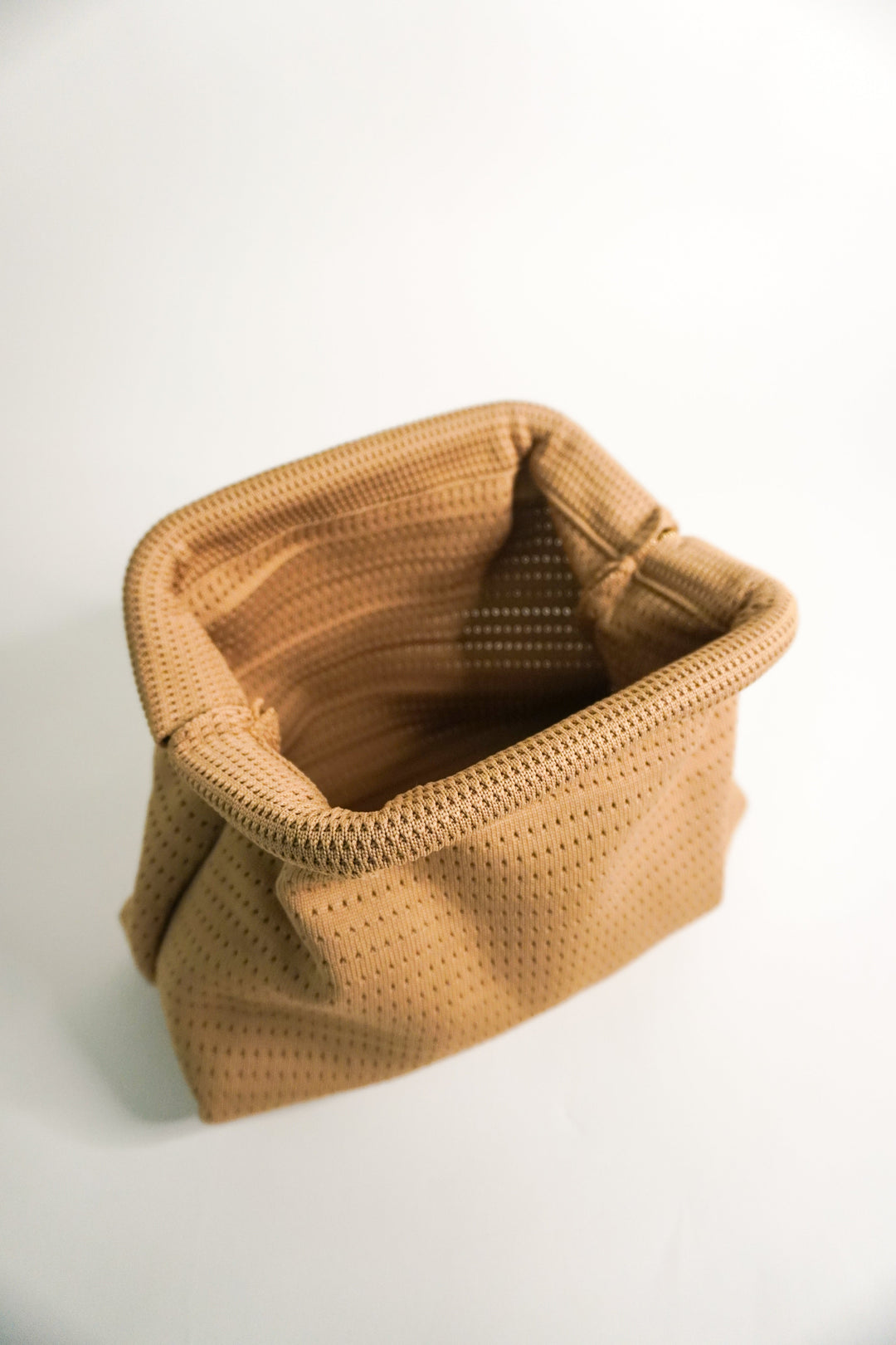 Beige Everywhere clutch interior view with open top and woven texture