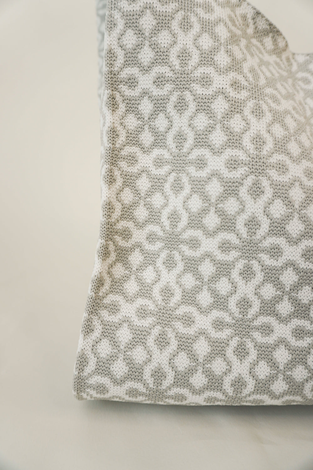 Grey Solitaire Handbag fabric close-up with repeating geometric motif.