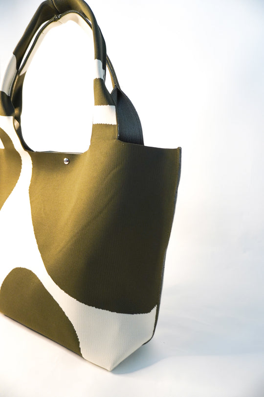 MOOdy Green Signature Tote angled view, wide base and short handles, green with white patches