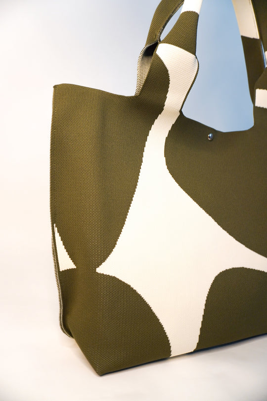 MOOdy Green Signature Tote side view, sturdy handles, green-and-white geometric pattern