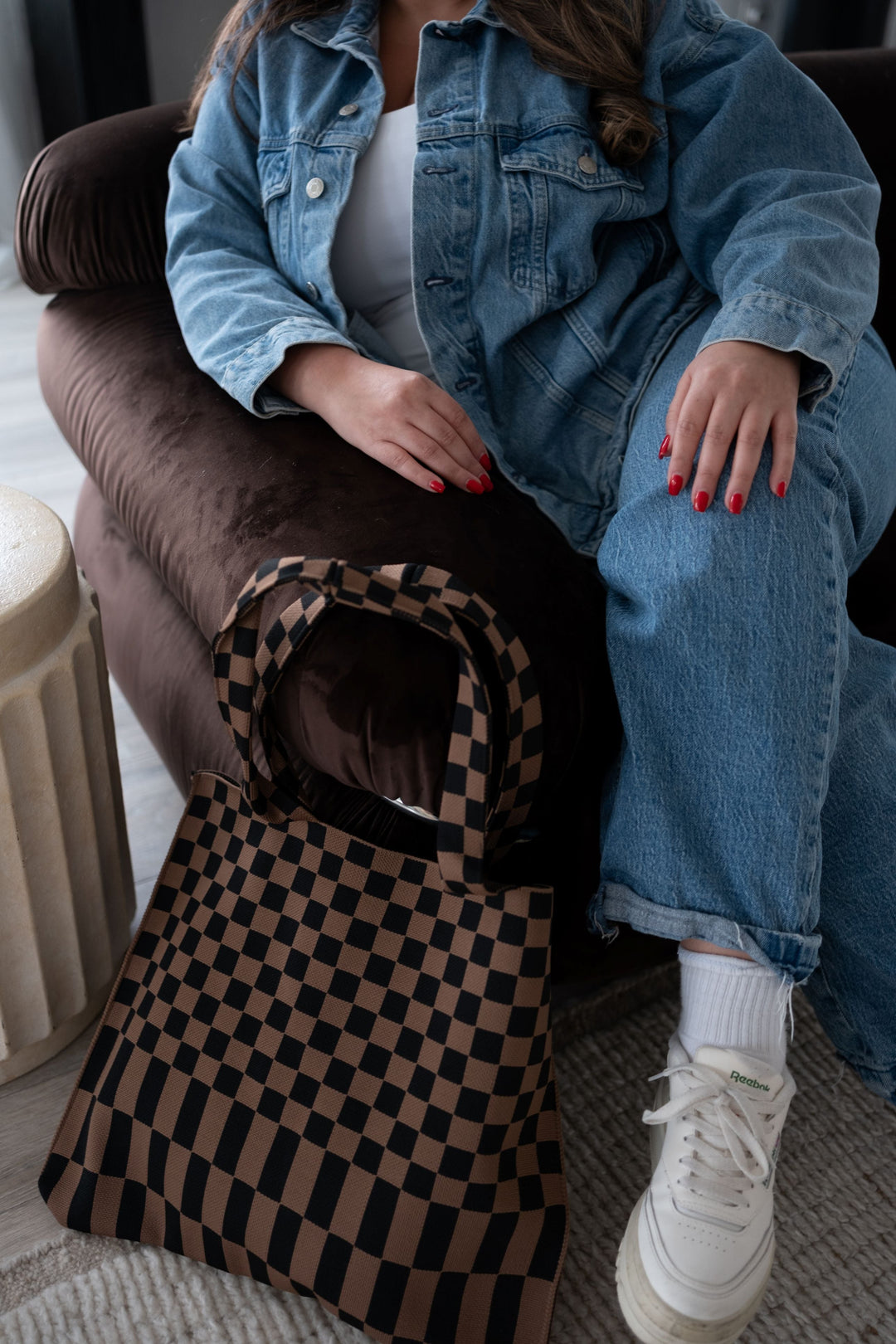 Skinny tote bag with brown-and-black checkered pattern and curved handle opening.