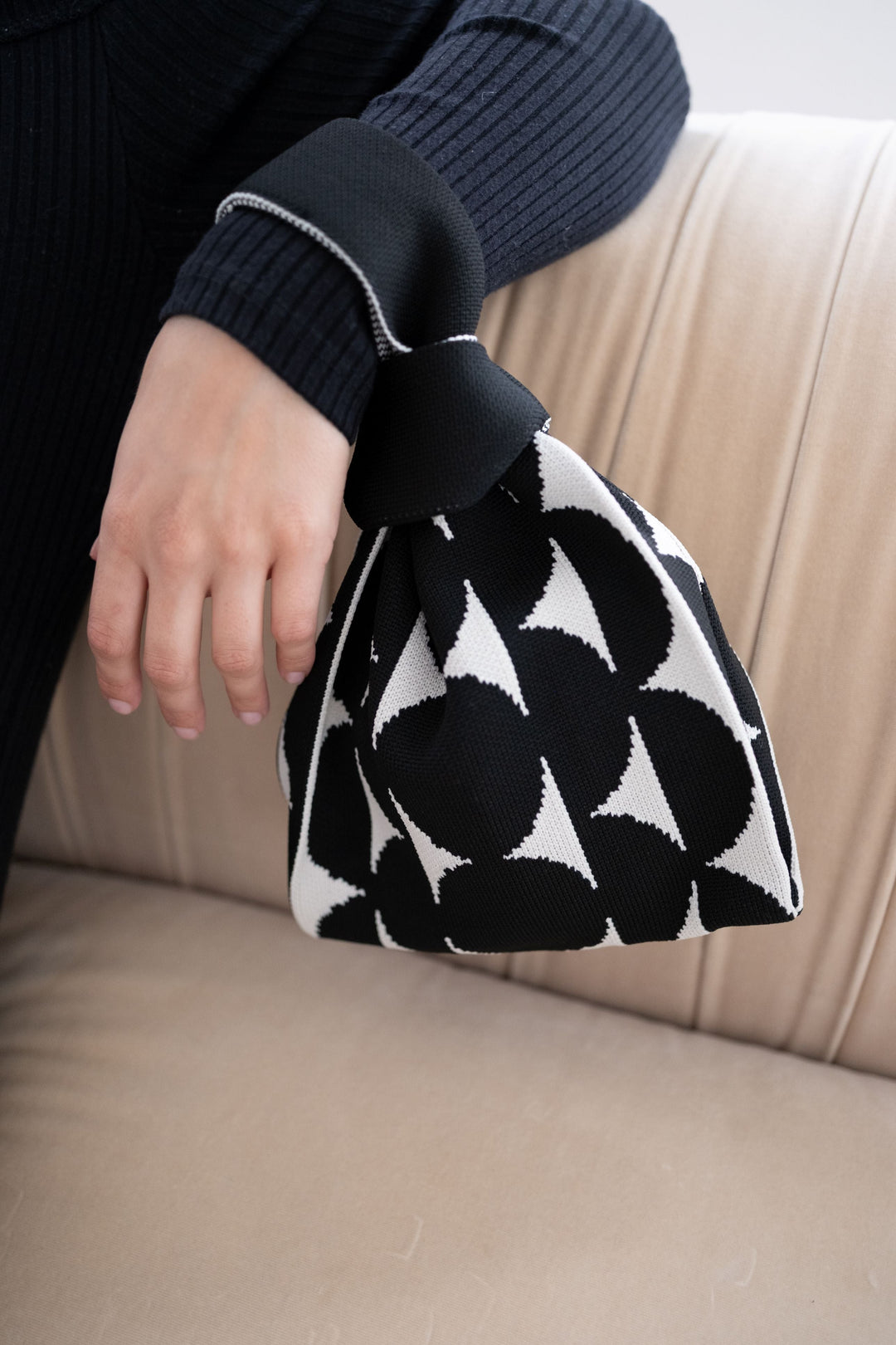 Black Portobello handbag side view, black drawstring and black-and-white fabric print
