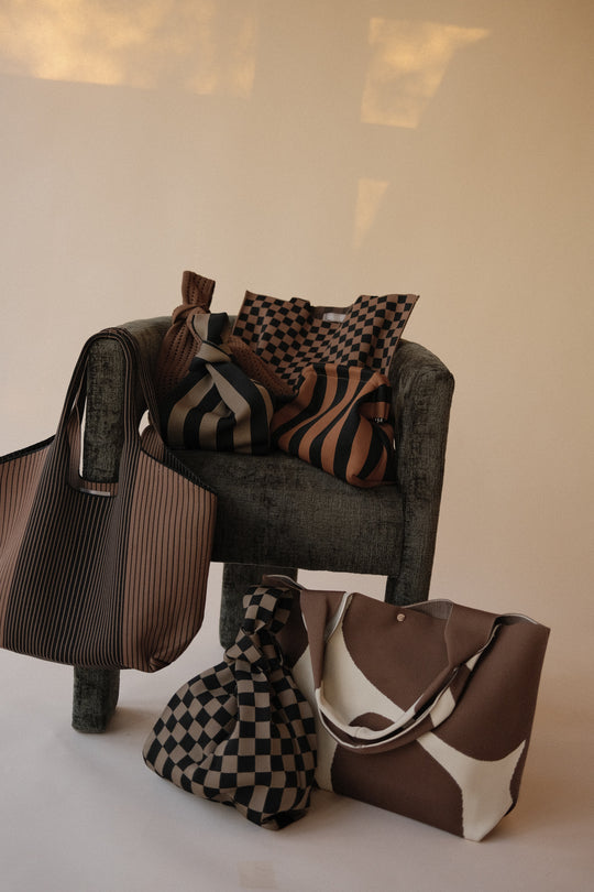 Multiple crochet totes and bags in brown and striped designs, styled together
