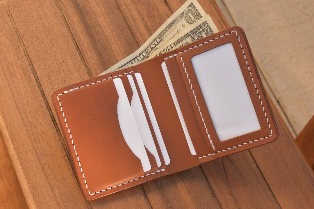 Open ID bi-fold wallet with cash in card slots and ID window, brown leather