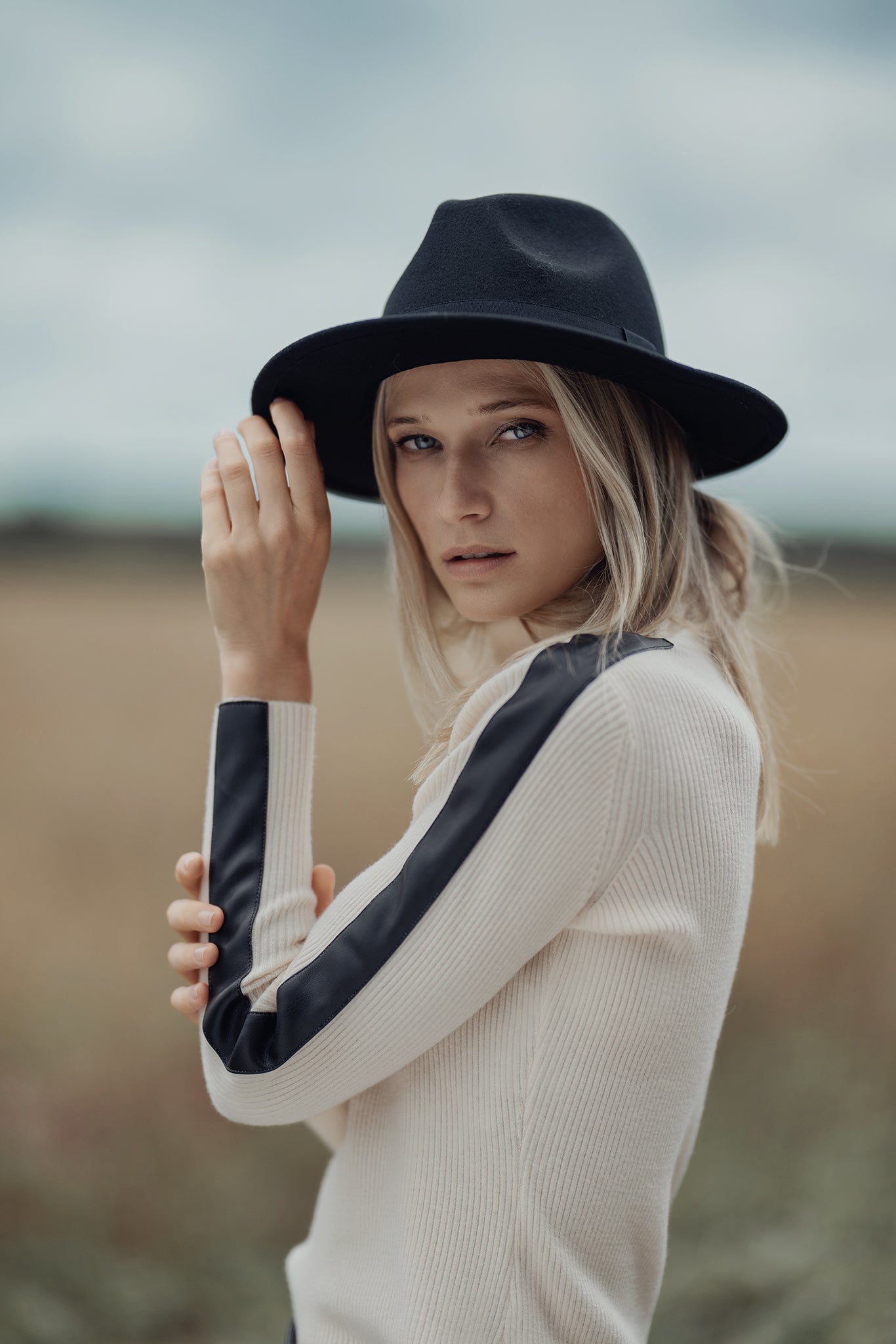 Ivory turtleneck sweater with black leather trim