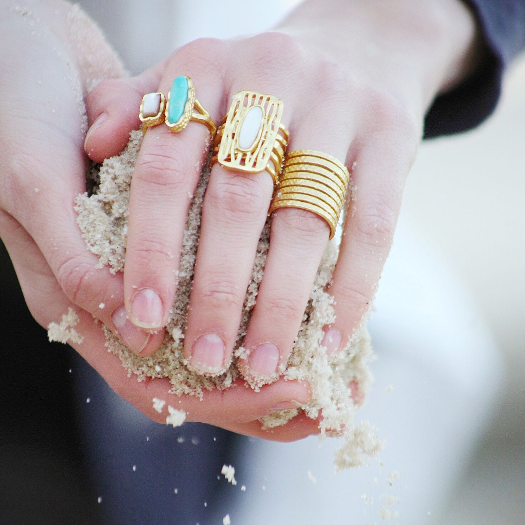 Gold Plate stackable wire rings on hand, multiple stacked bands visible