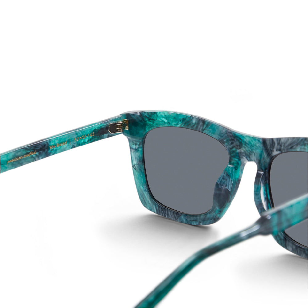 Devlin sunglasses: rectangular teal frame with dark gray lenses and bridge detail
