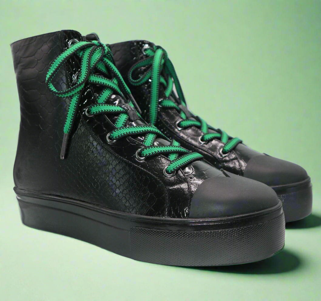 Pair of black high-top sneakers with green laces and textured leather look