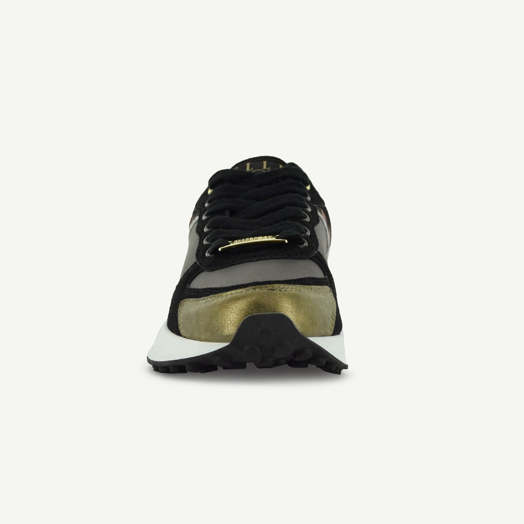 Retro Runner heel view: black-and-gold upper panel with cushioned collar and tread sole