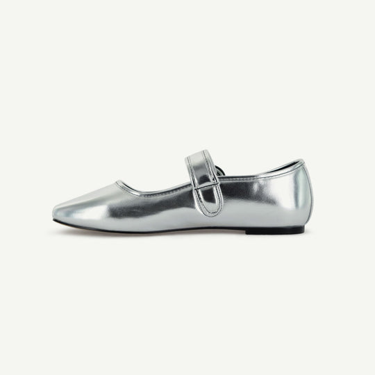 Silver Mary Jane flat side view with buckle strap and low black sole