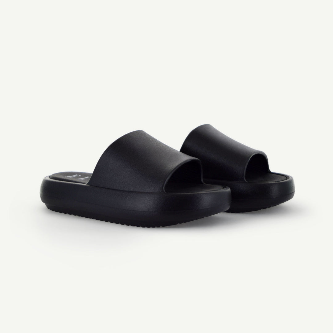 Pair of black platform slides with open toe and chunky sole.