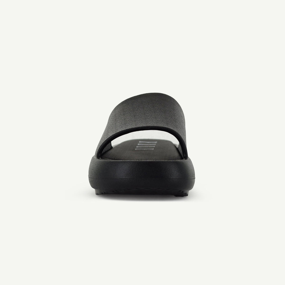 Black platform slide heel view with embossed logo on the footbed.