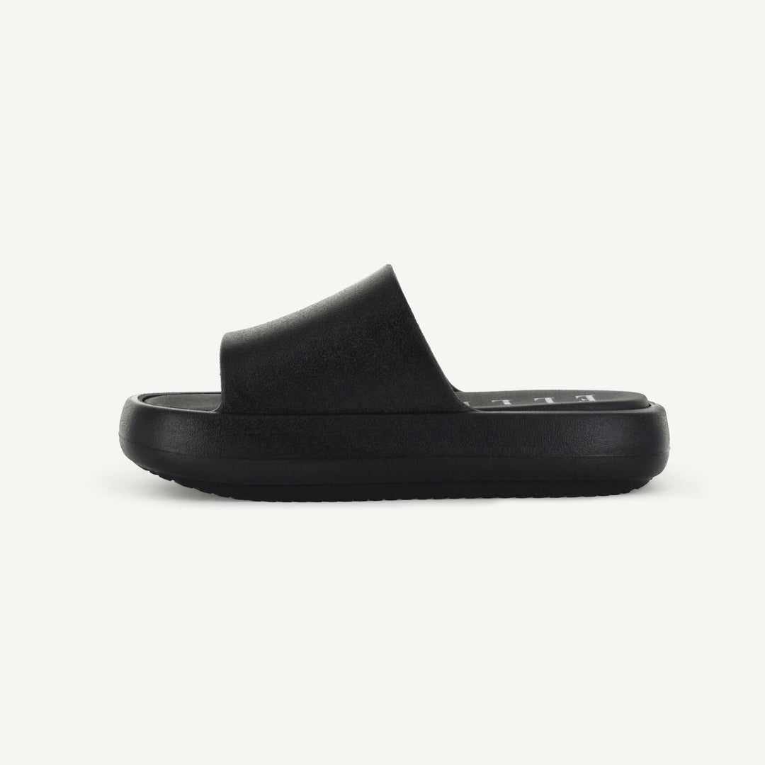 Black slide sandal, side view with thick platform sole.