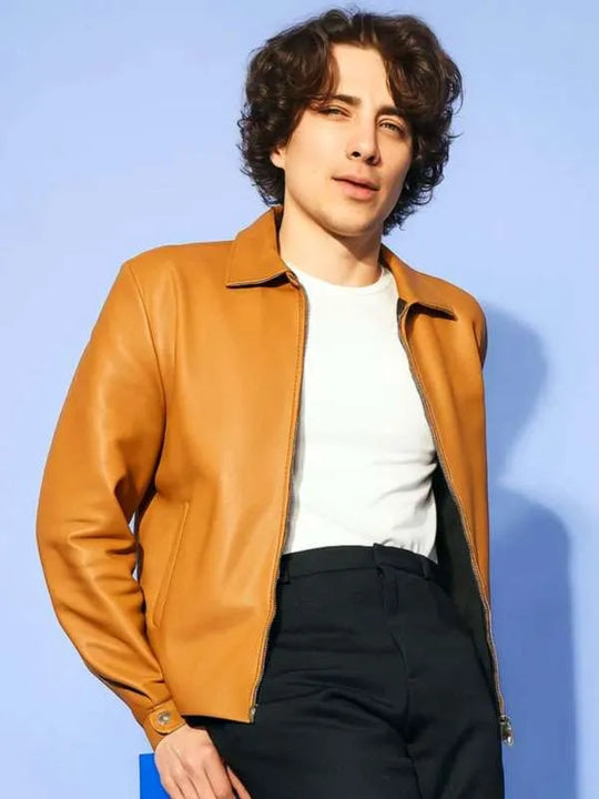Tan leather jacket with zip front, stand collar, long sleeves, zippered cuffs