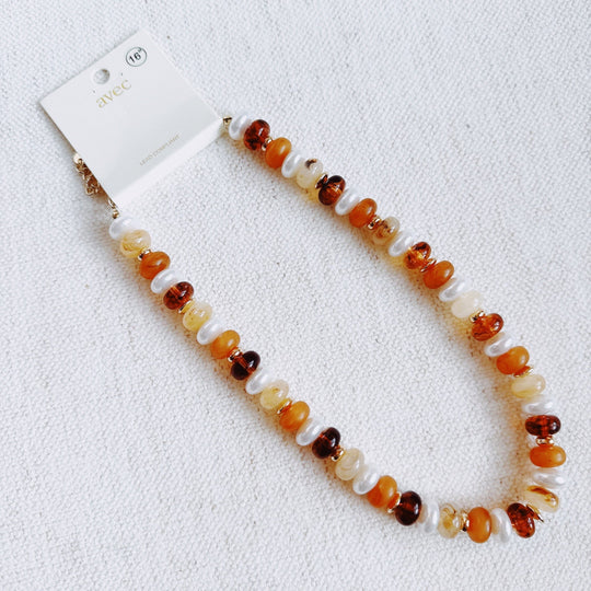 Ellisonyoung.com beaded necklace; warm orange, amber, and white round beads with clasp