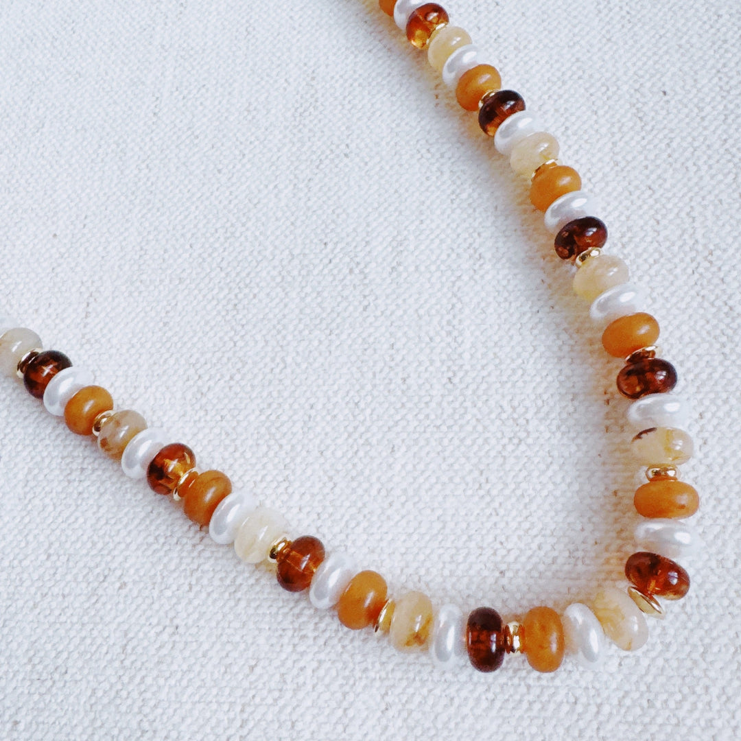 Golden Earth beaded necklace with warm orange, amber, and white stones, round beads