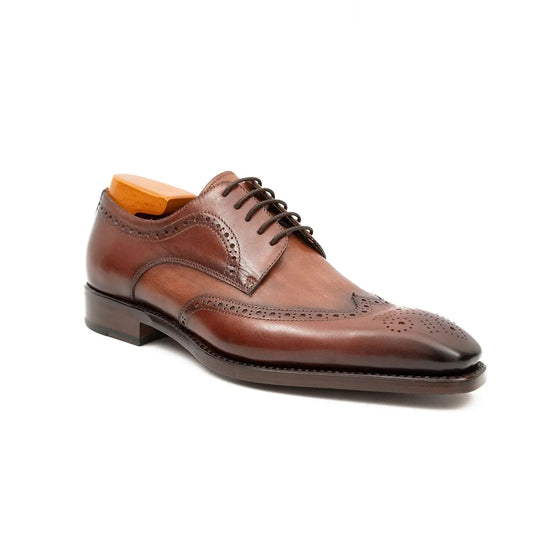 Brown brogue derby shoes, angled front view with perforated toe and laces