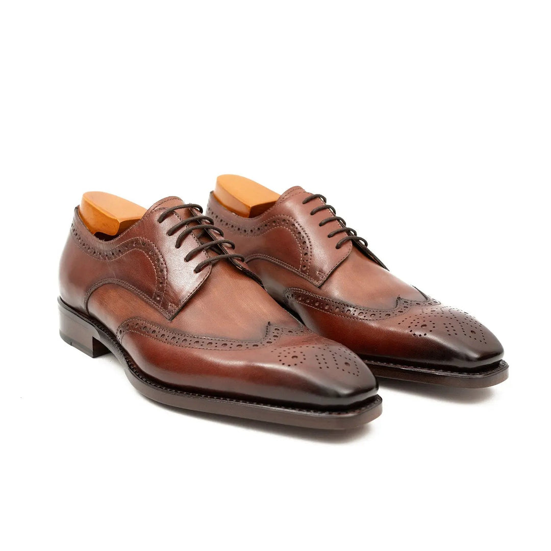 Brown brogue derby shoes, pair side-by-side view with dark sole edge