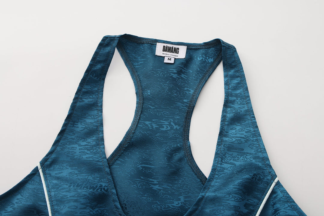 Forest blue sleeveless top, close-up of back neck and arm openings with white trim