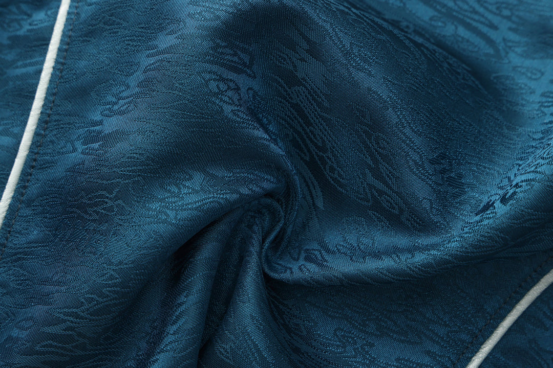 Forest blue sleeveless top fabric close-up with subtle pattern