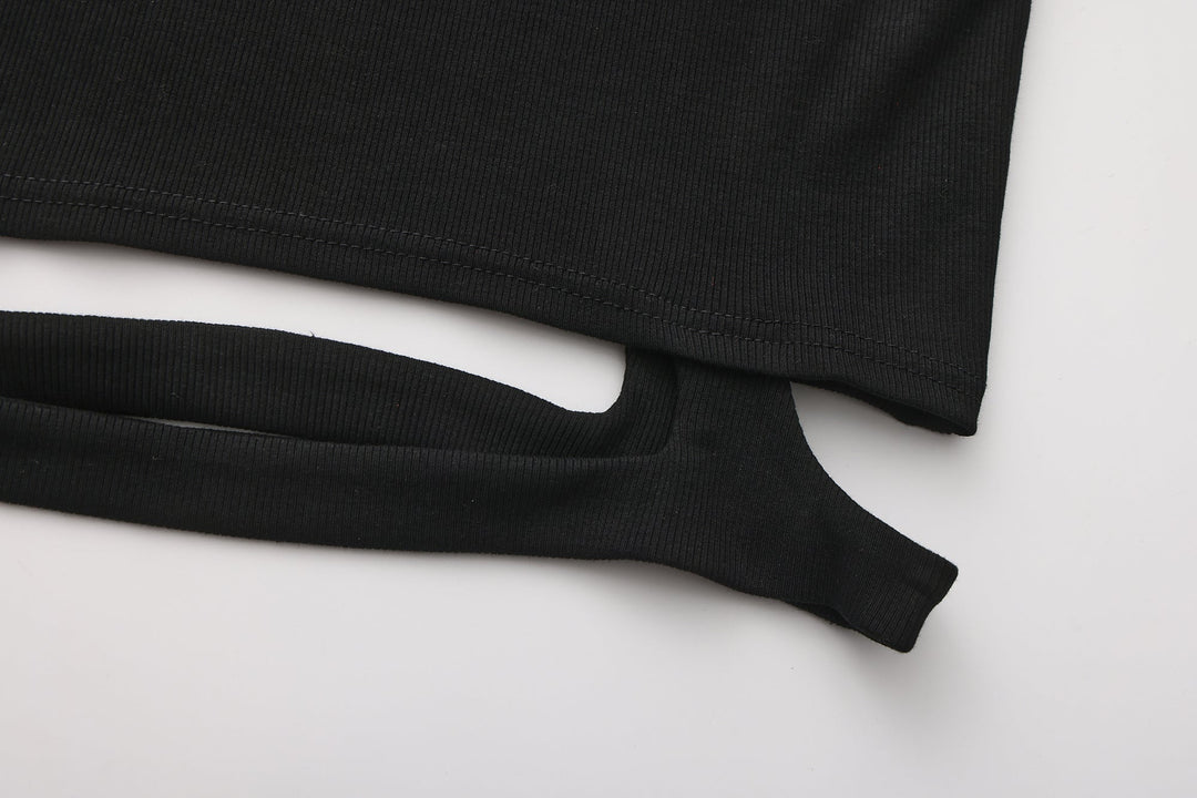 Black knit crop top hem cutout with long sleeves, curved opening detail.