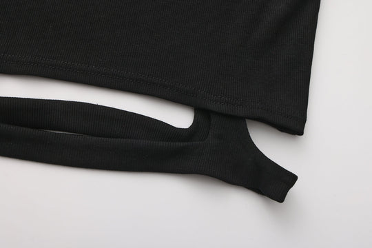 Black knit crop top hem cutout with long sleeves, curved opening detail.