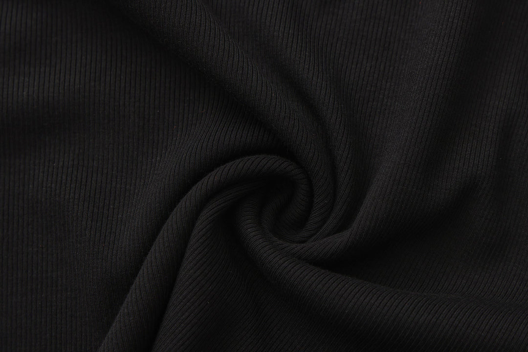 Black ribbed knit fabric texture for long-sleeve crop top.