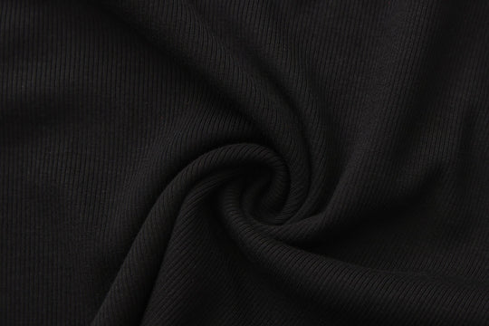 Black ribbed knit fabric texture for long-sleeve crop top.