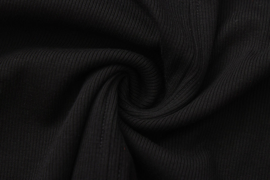 Close-up of black ribbed knit fabric with soft folds