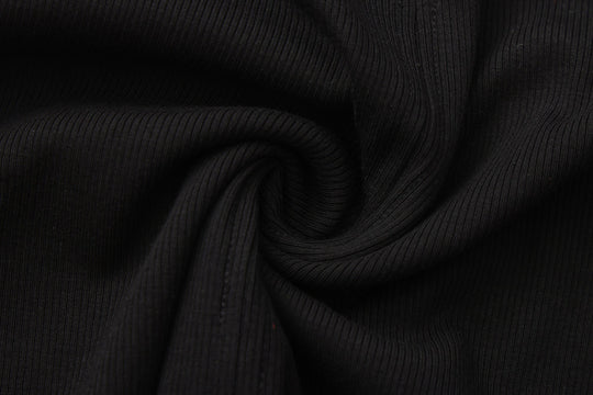 Close-up of black ribbed knit fabric with soft folds