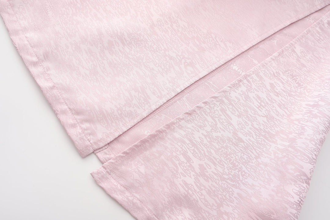 Fei Patch Maxi Skirt fabric close-up: light pink jacquard texture and curved seam.