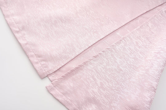 Fei Patch Maxi Skirt fabric close-up: light pink jacquard texture and curved seam.