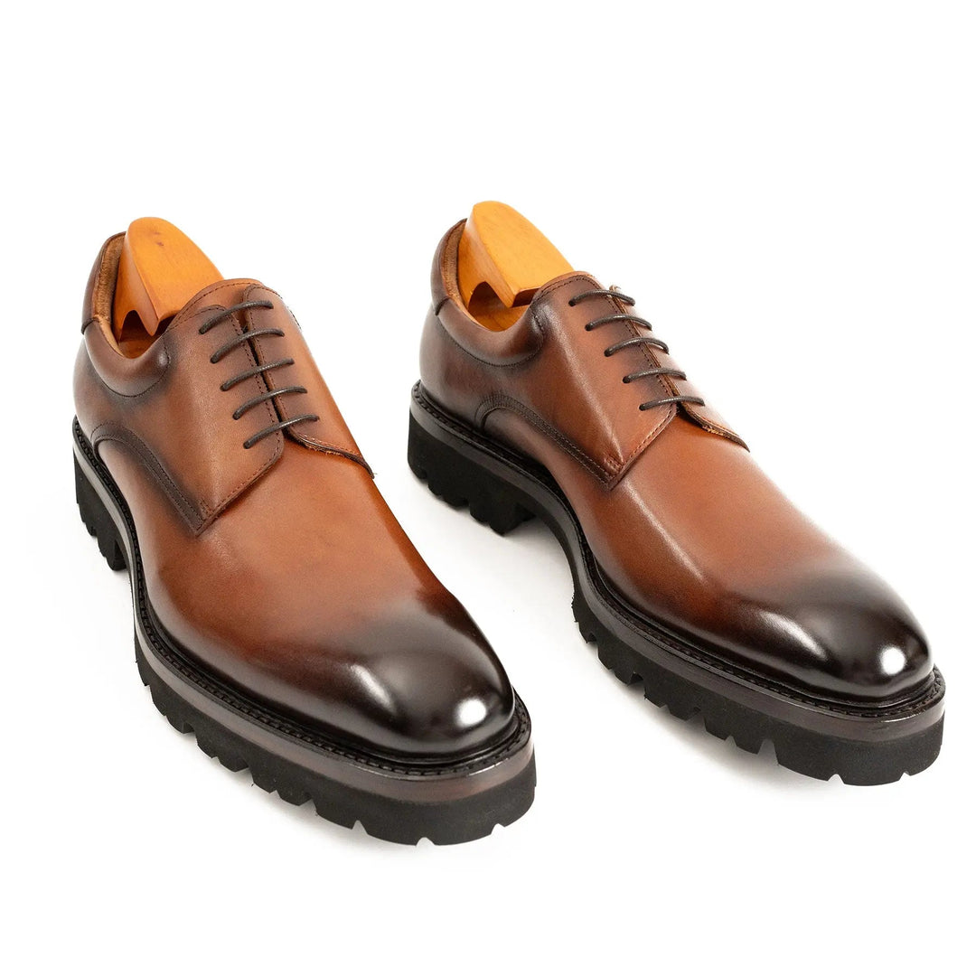 Brown leather derby shoes, lace-up with sleek cap-toe and lug sole