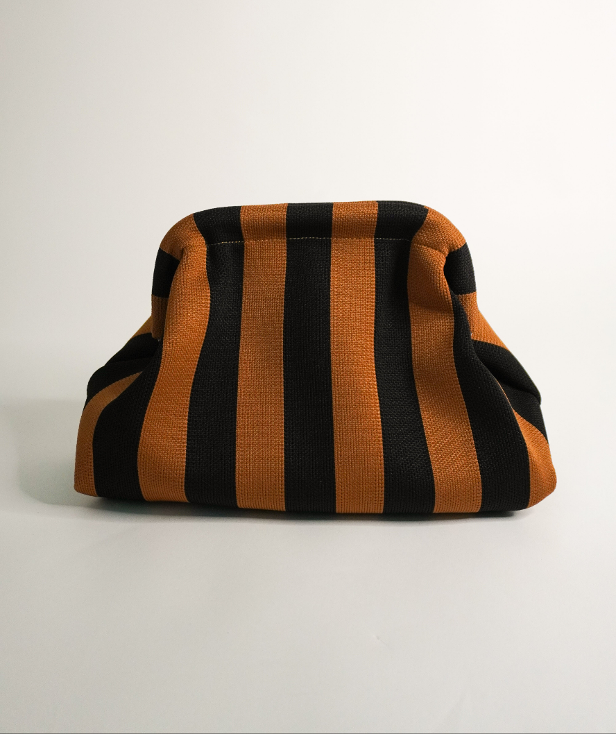 Brown and black striped clutch bag with curved top and fabric handles