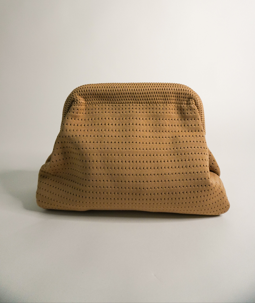 Beige woven clutch with rounded top and curved flap closure