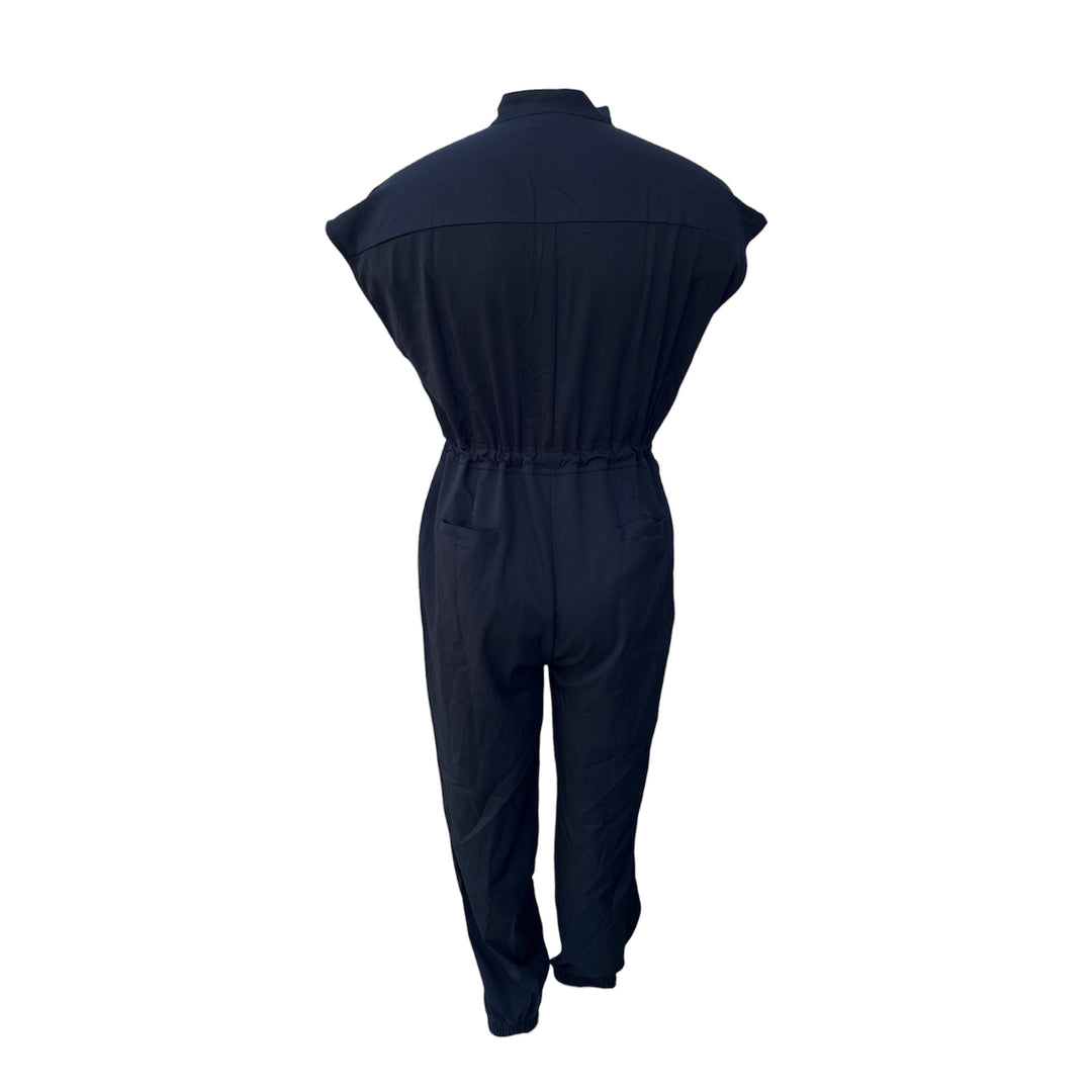 Black scrub jumpsuit, back view with yoke seam, elastic waist, tapered jogger legs.