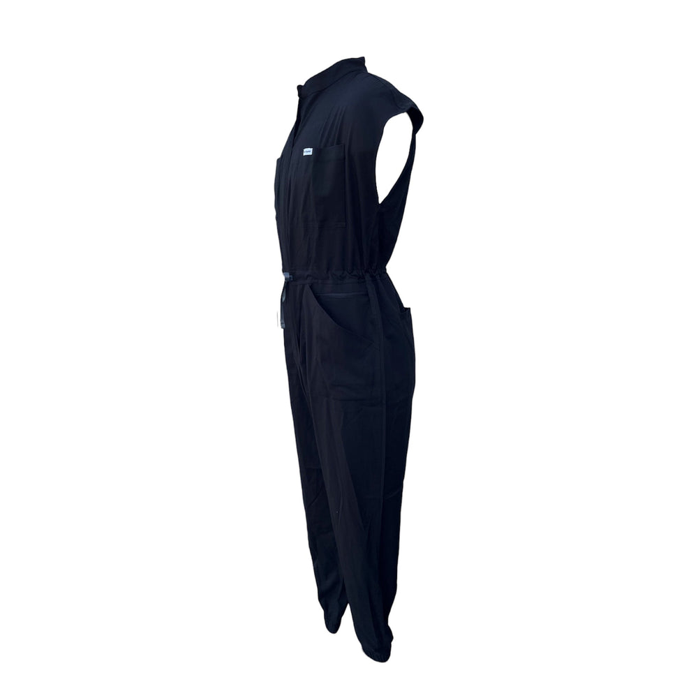 Black scrub jumpsuit, side view with adjustable drawstring waist and patch pockets.