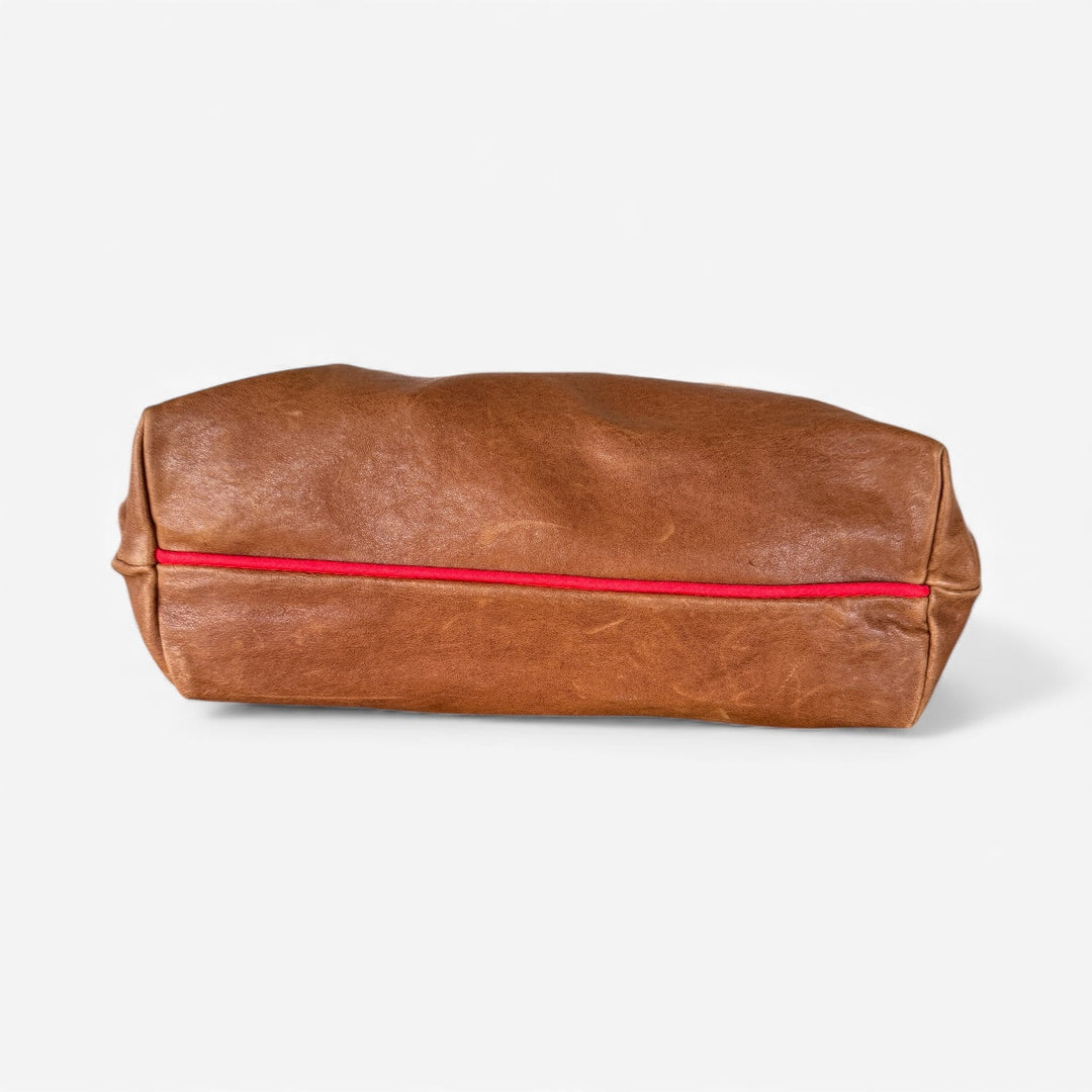 Brown leather hobo bag with contrast red stripe along the back panel