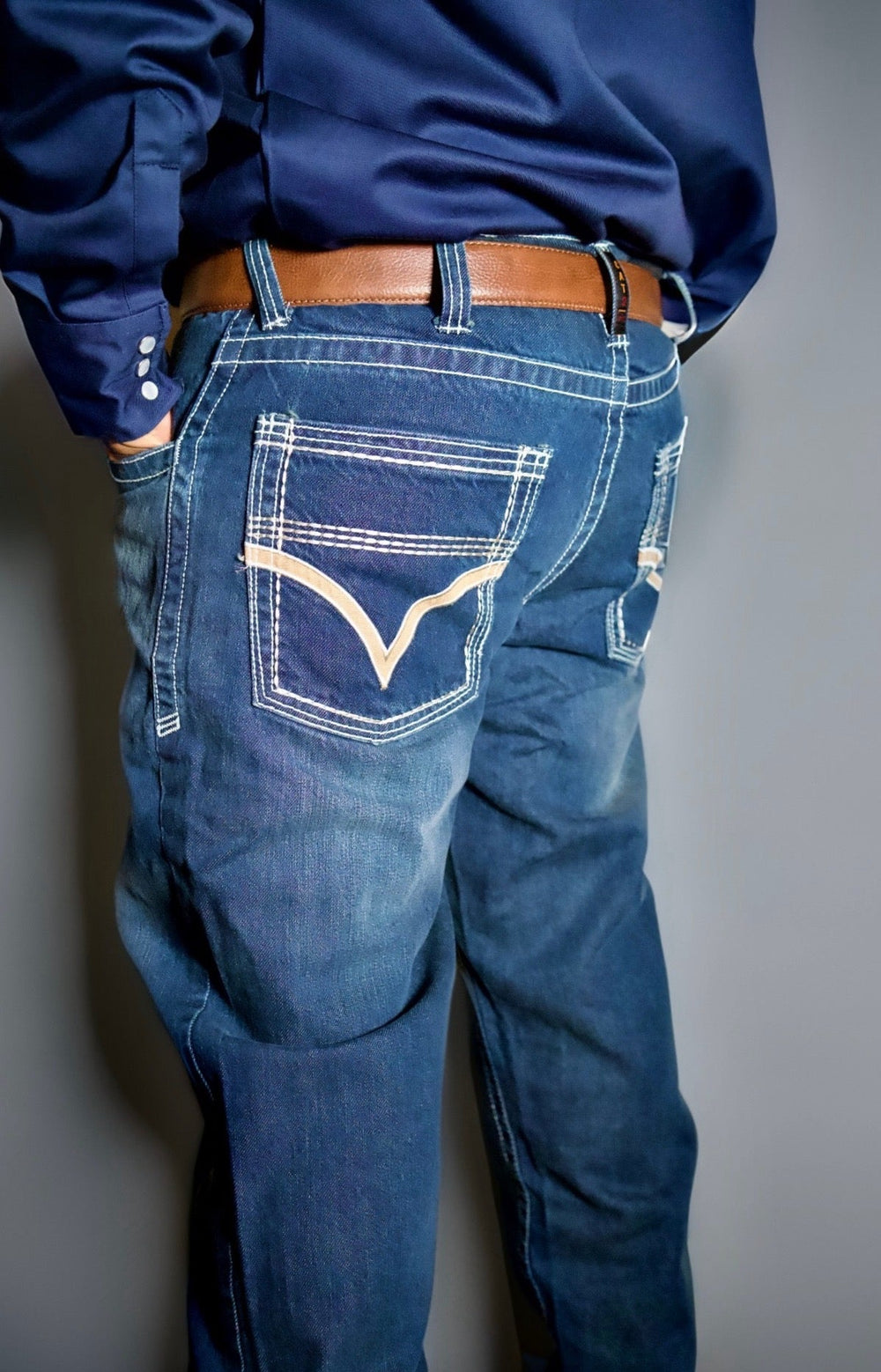 Back view of bootcut relaxed jeans, dark blue wash, stitched back yoke and pocket