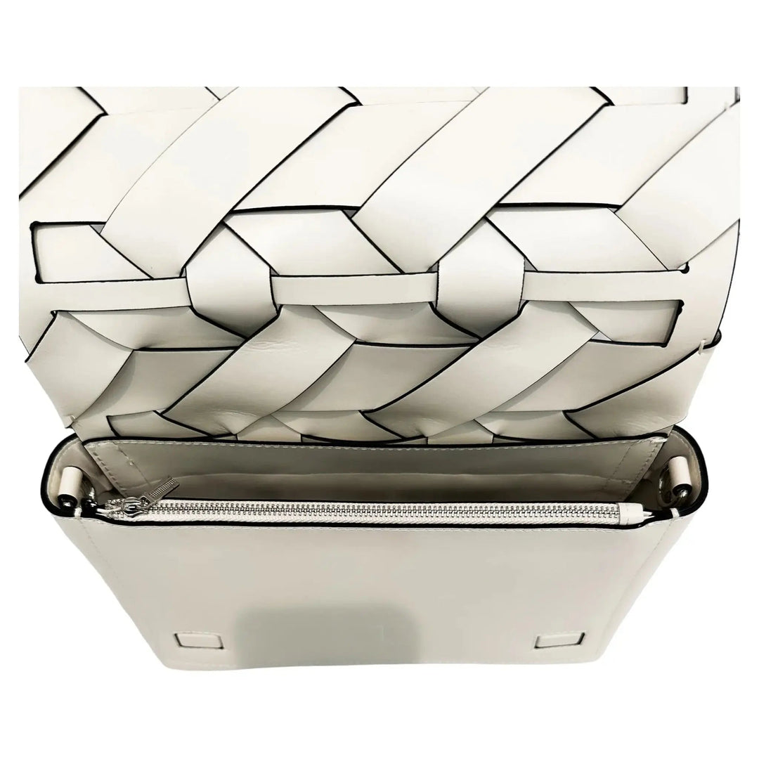 Ivory woven clutch interior view with exposed zipper and layered geometric edges
