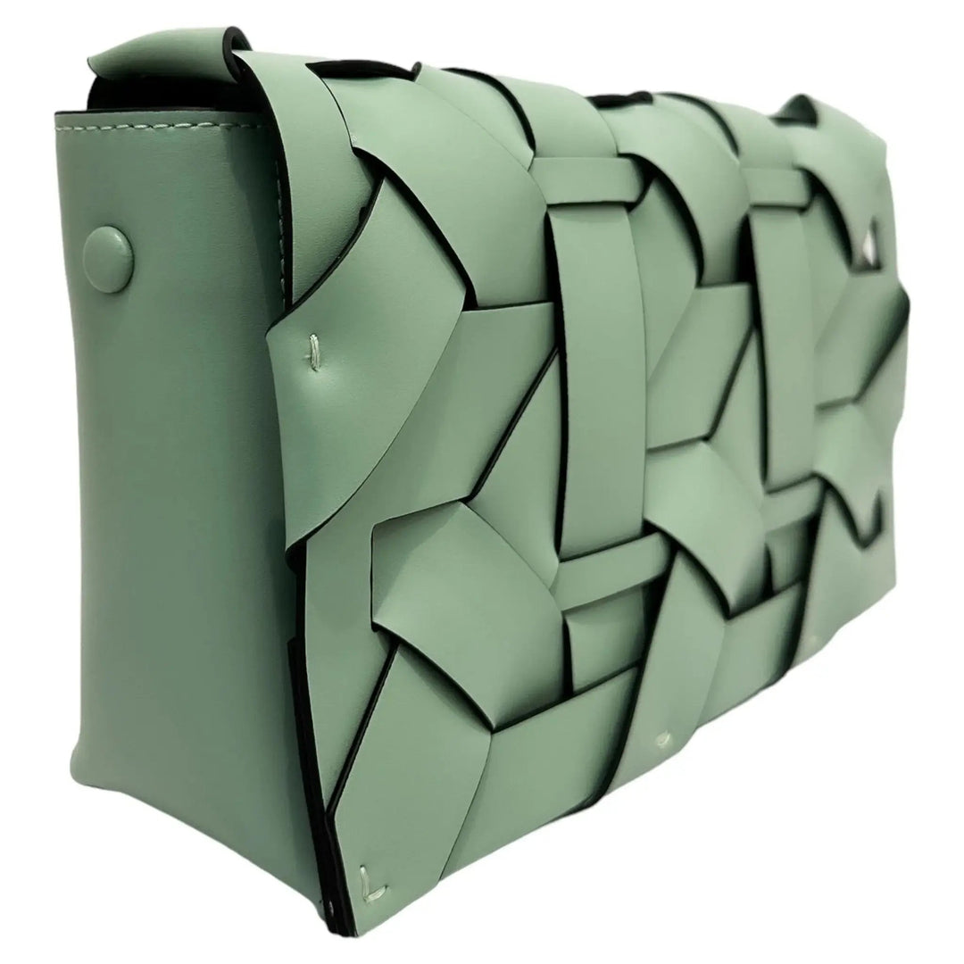 Pistachio green THE ZENOBIA woven clutch side view with structured geometric pattern