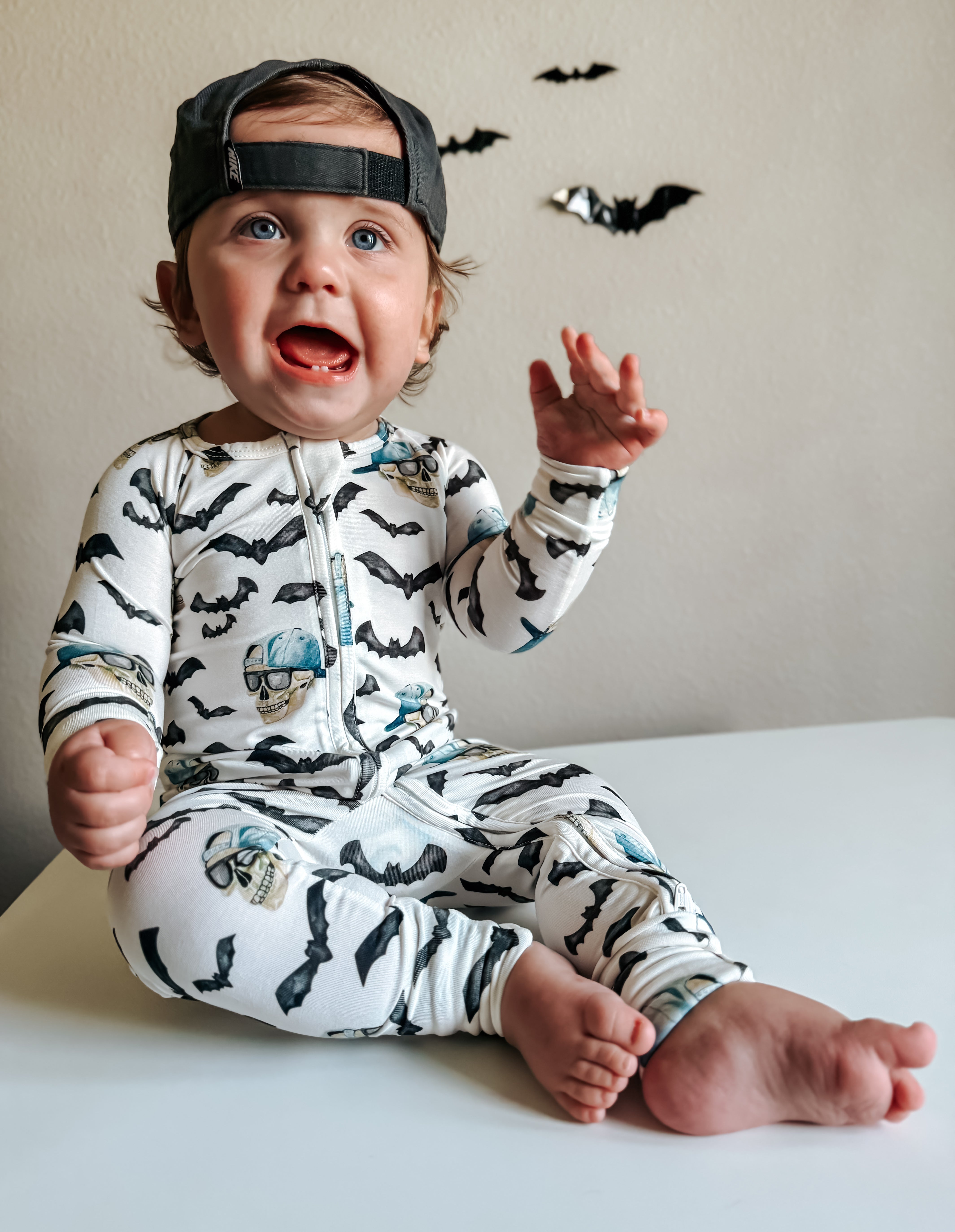 Zippy pajamas with zip front, white fabric, black bats, blue skull prints, long sleeves