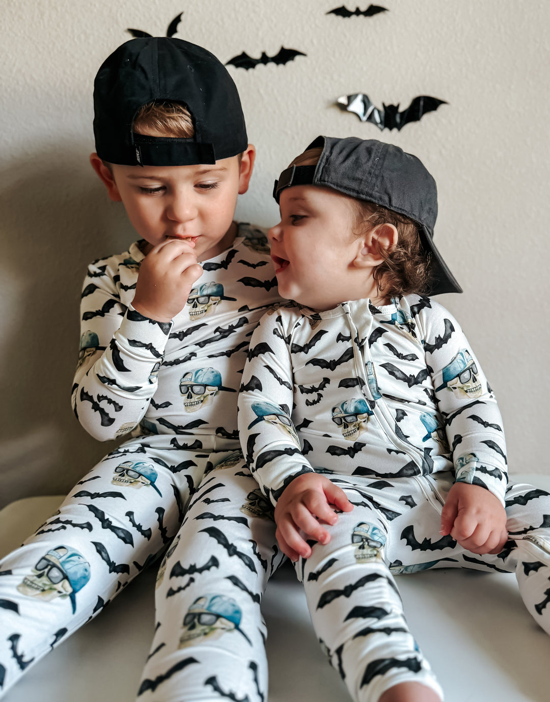 Bamboo zippy pajamas with zipper front, bat pattern and blue skulls on white fabric