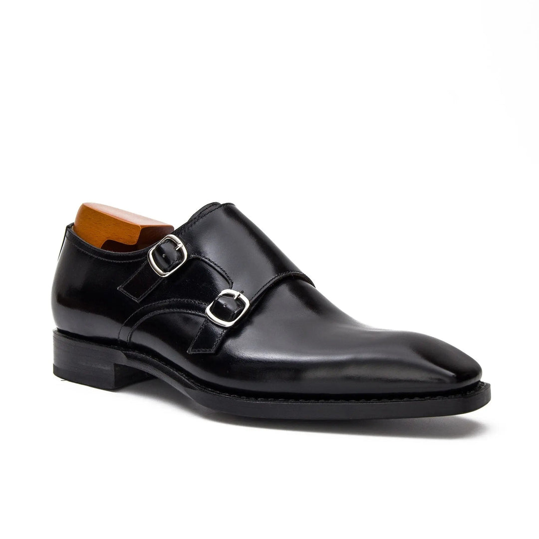 Black double monk shoes with two buckle straps, front-side view
