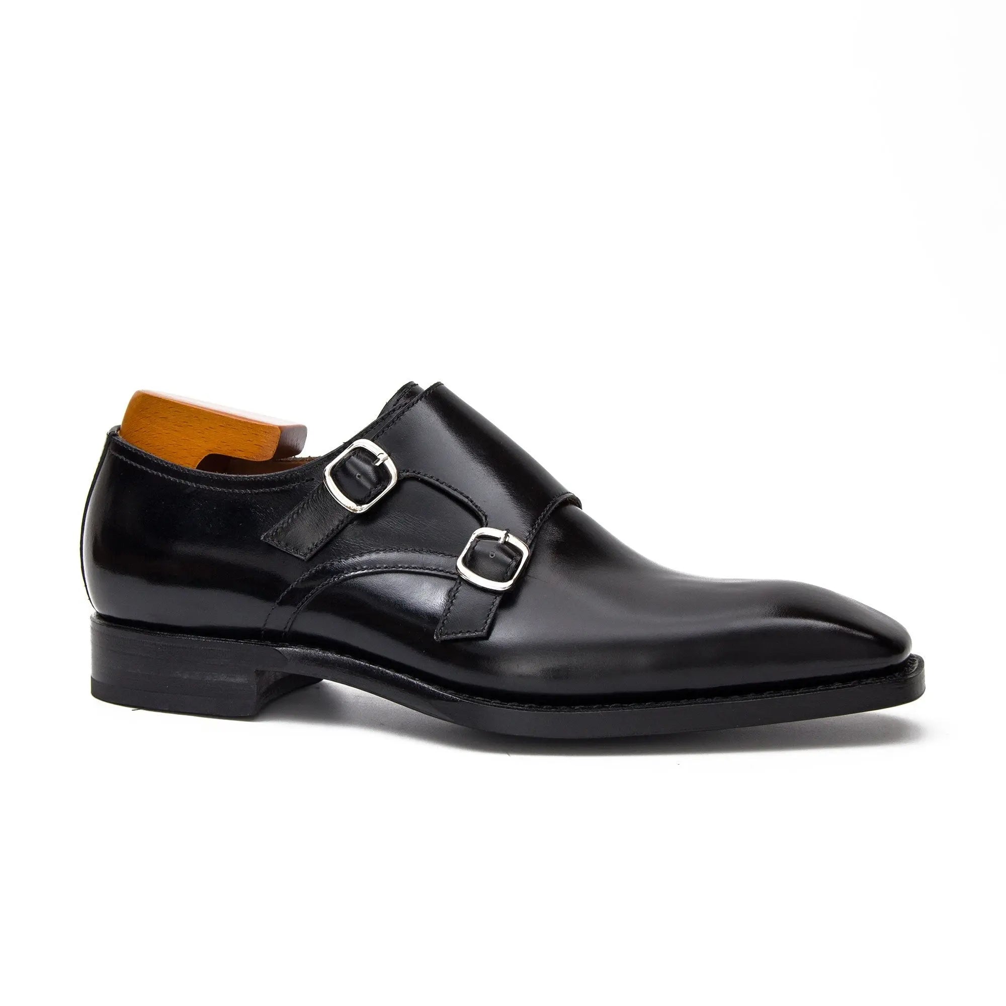 Black double monk shoes with two metal buckles, side view