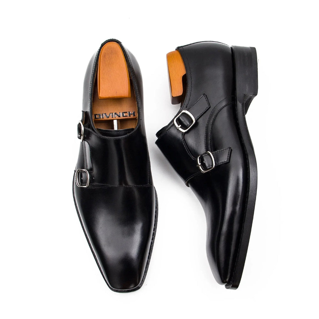 Black double monk shoes, angled top view showing two buckles and sleek toe