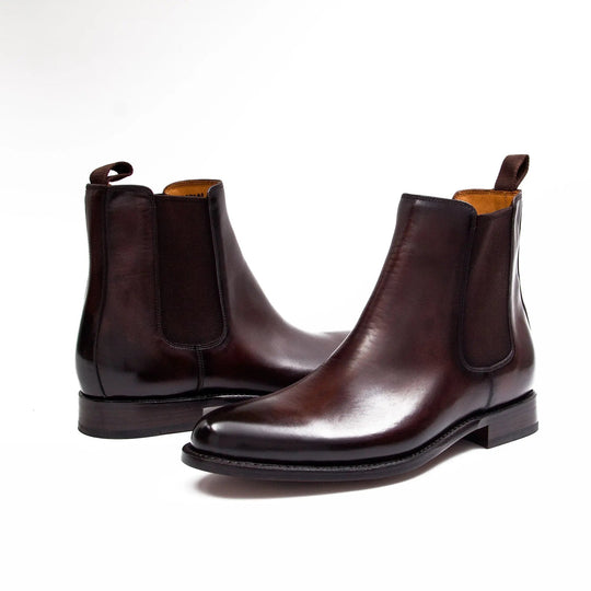 Brown leather Chelsea boots with elastic sides and cushioned-looking insole opening